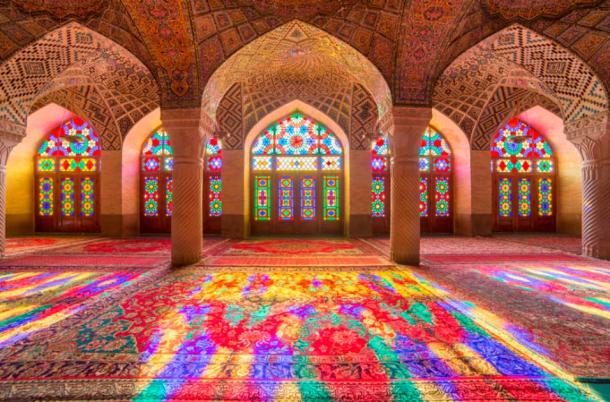 Nasir Al-Mulk Mosque, also known as the Pink Mosque, is a mosque located in Shiraz, Iran. It was built in the late 19th century during the Qajar dynasty by the order of Mirza Hasan Ali Nasir al Molk. The mosque is famous for its stunning interior, with intricate stained-glass windows and colorful tiles that create a beautiful interplay of light and color. Source: Mazur Travel / Adobe Stock