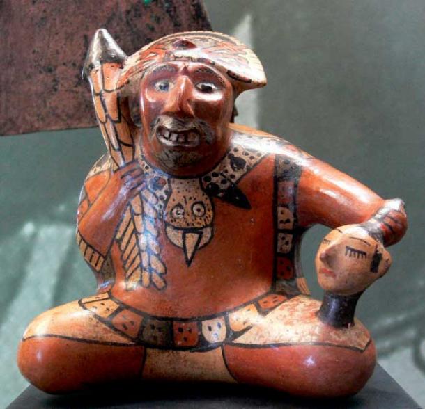 Nazca pottery showing a warrior holding a severed human head (Public Domain)