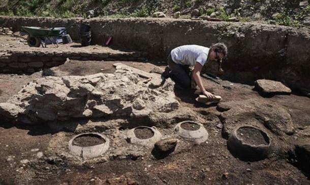 One of the French archaeological team cleaning household artifacts at the site at Sainte-Colombe in Vienne, France (Credit: Jean-Philippe Ksiazek/AFP)