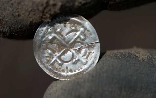 One of the coins found at the site. (YouTube Screenshot)