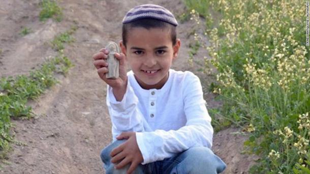 Ori Grinhot shows off the figurine he found.