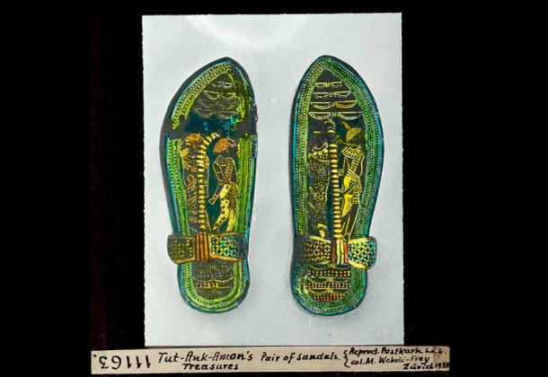 Pair of sandals depicting bound enemies, Nubian and Asiatic, made from wood and overlaid with a marquetry veneer of bark, green leather and gold foil on a stucco base. They were discovered within the tomb of Tutankhamun and are now on display in the Egyptian Museum in Cairo. (Leo Wehrli / CC BY-SA 4.0)