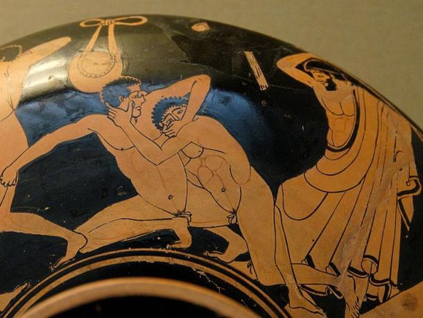 Pankration scene: The pankratiast on the right tries to gouge his opponent's eye; the umpire is about to strike him for this foul. Detail from an Ancient Greek Attic red-figure kylix, 490–480 BC, from Vulci. British Museum, London.