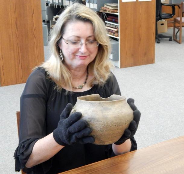 Photograph taken by Lewis Hales May, 2015, at the Thomaston-Upson Archives of former Archives Director Penny Cliff inspects the vase.