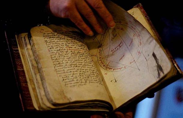 Person thumbing through a grimoire.