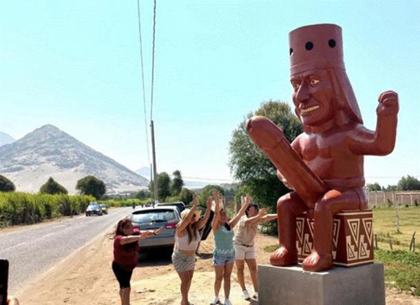 Mujeres peruanas rezando a la estatua fálica Huaco Erotico Moche, que fue objeto de vandalismo recientemente. (Municipalidad Distrital de Moche)