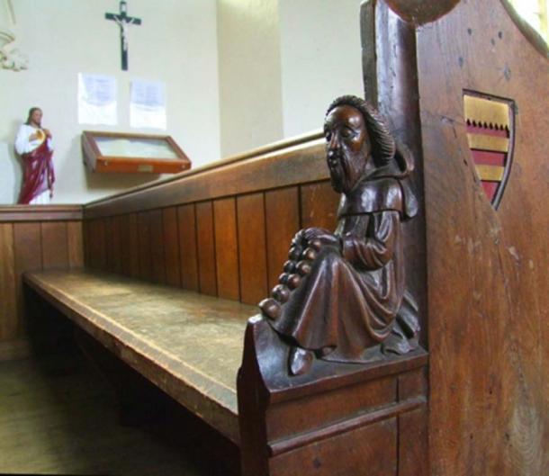 Picture from 2016 of one of the ornate pews of St Mary the Virgin Church in Wimbotsham. One of the wooden figures carved by James Rattee in 1853. Picture: Simon Knott