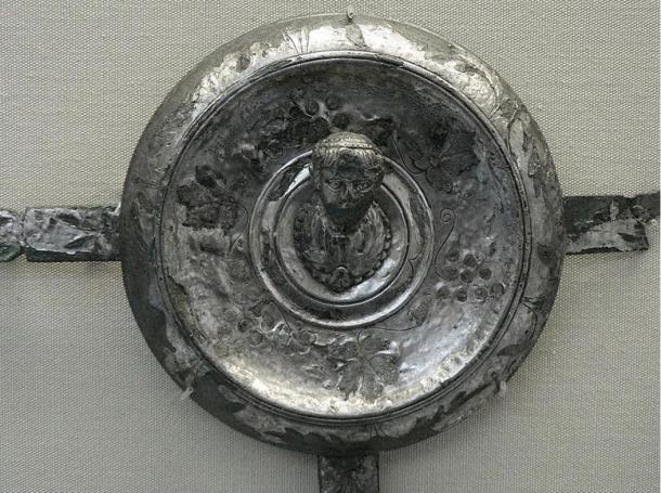 “Pliny the Elder's phalera bears an inscription formed from punched dots: PLINIO PRAEF EQ; i.e., Plinio praefecto equitum, ‘Pliny prefect of cavalry’. It was perhaps issued to every man in Pliny's unit. The figure is the bust of the emperor.” Circa 50 AD.