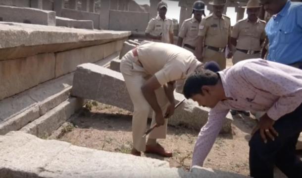 Police visiting the site to review the damage. (YouTube)