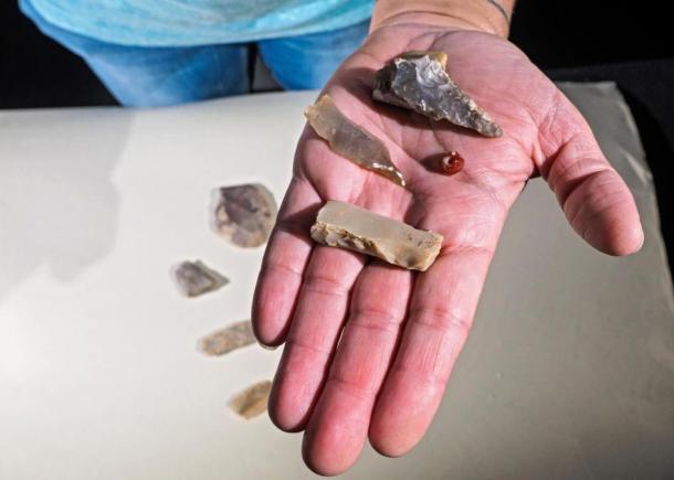 Polished flint axe and blades and a gemstone bead discovered in the excavation in Jerusalem.