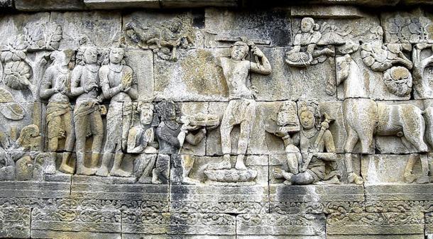 Prince Siddharta Gautama shaves the hair off his head as the sign to decline his status as ksatriya (warrior class) and becomes an ascetic hermit, his servants hold his sword, crown, and princely jewelry while his horse Kanthaka stands on right. Bas-relief panel at Borobudur, Java, Indonesia.