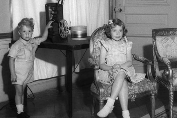 A young Princess Christina and her brother see a film in one of their rooms at Drottningholm Palace.
