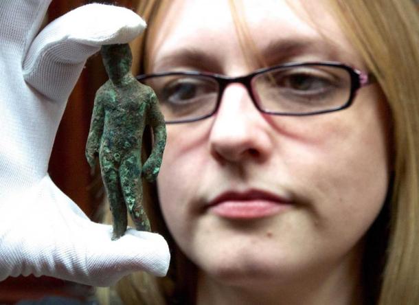 Rebecca Griffiths of York Museums Trust with the copper alloy figurine of Mercury.