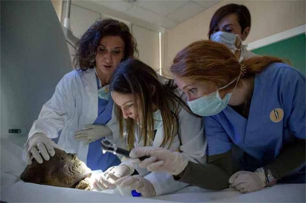 Researchers at Milan’s Mummy Project examining an Egyptian mummy before a CT scan in their quest to learn more about Egyptian health and mummification. (Mummy Project)
