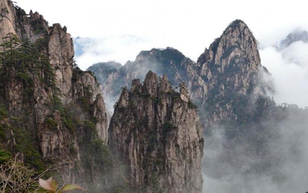 Rock formations and mountains at Huangshan, China. Visitors to the mountain may discern various real or mythical creatures in the rock formations. 