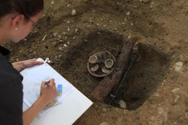 A researcher documents the Roman find.