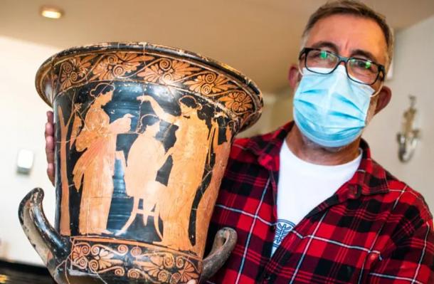 A stolen and recovered Greek vase painted in the red-figure style, looted from Israel, with Head of the Anti-Theft Unit at the IAA Amir Ganor. (Yuli Schwartz / IAA)