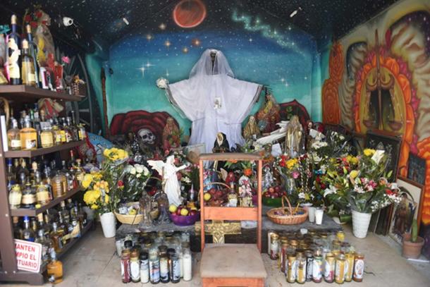 Santa Muerte shrine (©Toni François) Different colored candles are lighted for specific requests or purposes. A brown candle is for wisdom, a white candle for gratitude, a black candle for protection and vengeance, and more.
