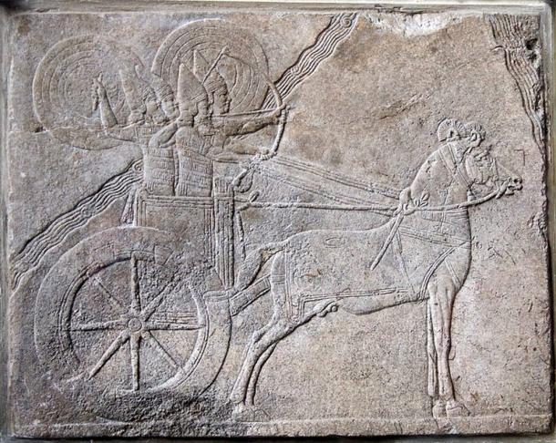 Scene from Ashurbanipal (668-627 BC) campaign against the Elamite city Hamaru, shows an Assyrian chariot with charioteer and archer protected from enemy attack by shield bearers. Assyrian relief from Nineveh. Alabaster relief, made about 650 BC. 