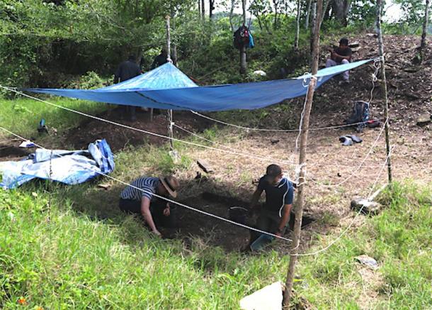 Schroder (left) and Scherer (right) excavate in the ballcourt which they enclosed with a fence to keep away nosy cows. (Image: Charles Golden)