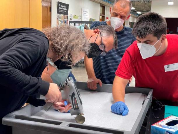 Scientists using an XRF gun to test the sword’s chemical composition (© Field Museum)