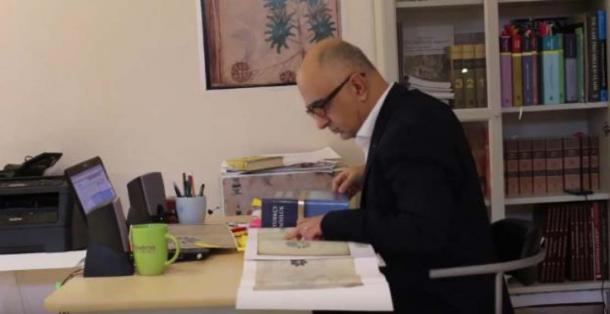 Screen shot from promotional video showing Mr. Ardic researching a copy of the Voynich Manuscript. (Voynich Manuscript Research/YouTube Screenshot)