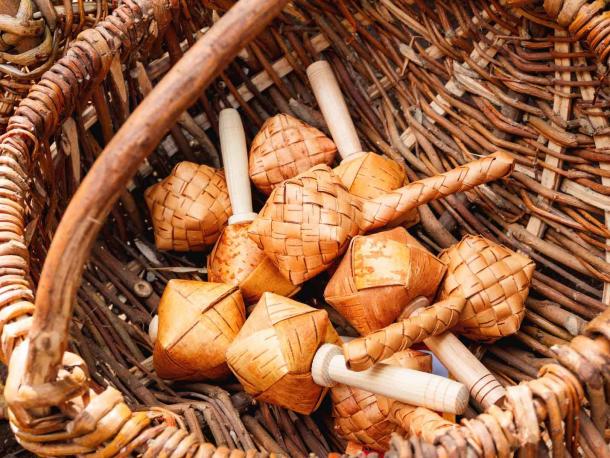 Sharkunok Russian baby rattles made from woven birch bark with seeds inside. A natural eco-friendly ancient toy. (Konstantin Aksenov / Adobe Stock)