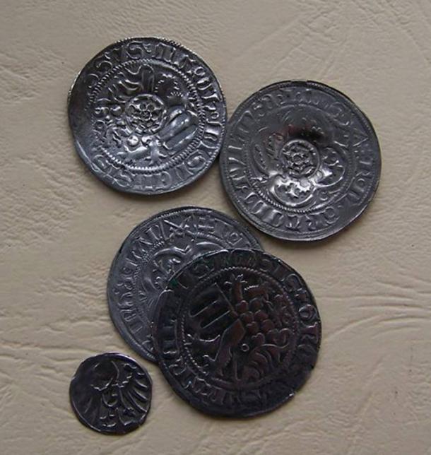 Silver coins found in a forest in Poland, as cleaned by archaeological restorers. 