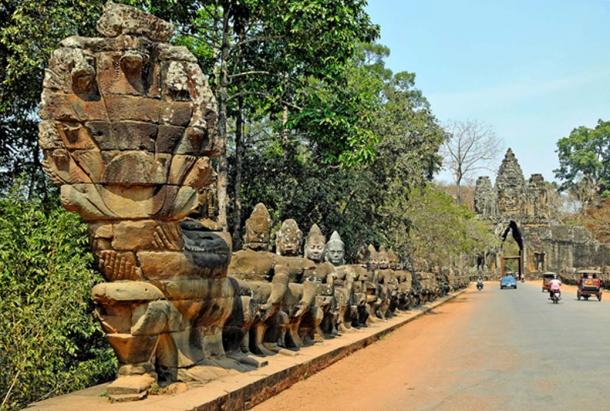 Statues at the South Gate of Angkor Thom in Cambodia, with gods holding the 9-headed serpent. 