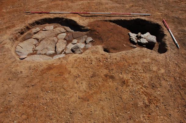 Stone-lined oven and rake-out material at Roman marching camp. (GUARD Archaeology / Fair Use)