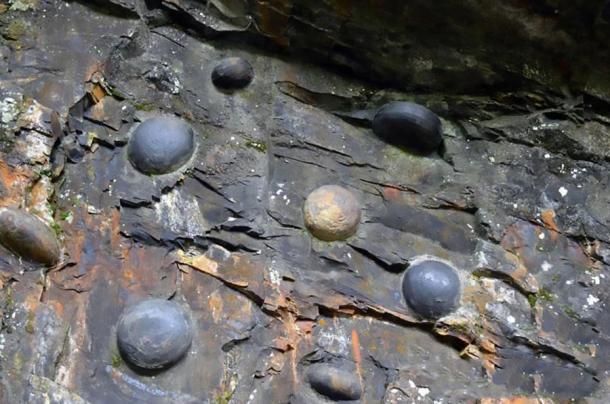 Stone eggs emerging from the Chan Dan Ya cliff. (AsiaWire)