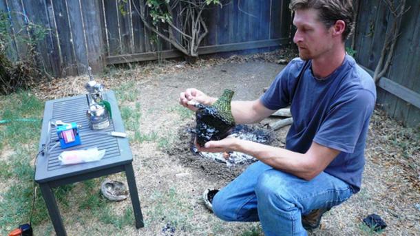 Study co-author Kevin Smith of the University of California, Davis, applies melted bitumen to a woven grass bottle. Instruments on the nearby table test for toxins in the air. (Photo by Sabrina Sholts)
