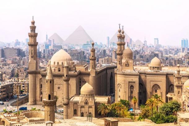 The Mosque-Madrassa of Sultan Hassan and the Pyramids in the background, Cairo, Egypt. (AlexAnton / Adobe Stock)