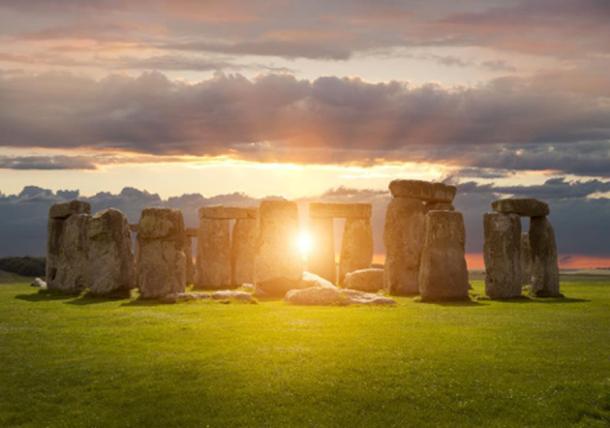 Sun shining through Stonehenge. (andrewmroland /Adobe Stock)
