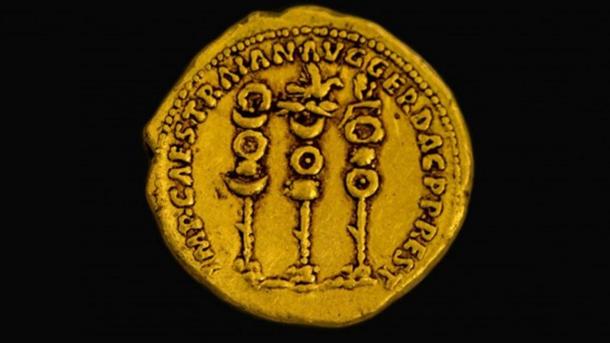 Symbols of the Roman legions next to the name of the ruler Trajan on a 2,000-year-old gold coin found in northern Israel. 