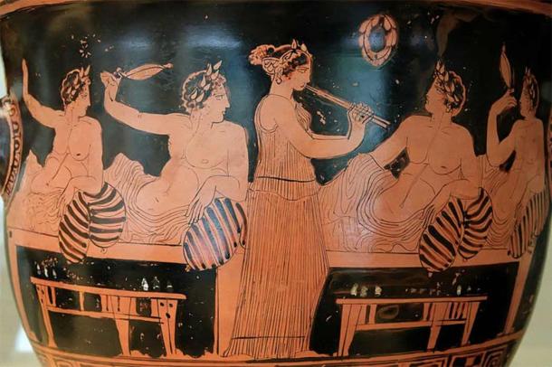 Symposium scene: banqueters playing the kottabos game while a girl plays the aulos. National Archaeological Museum (CC BY-SA 2.5)