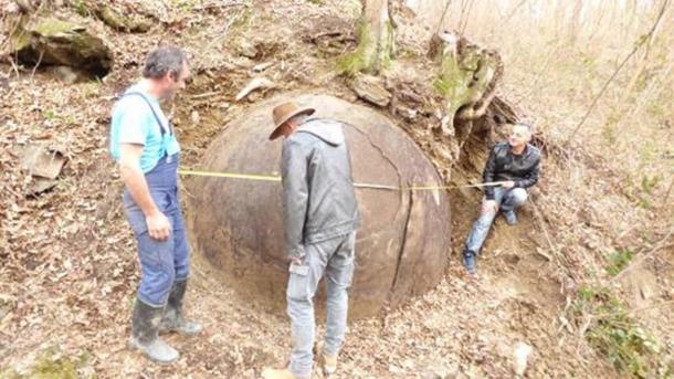 Taking measurements of the stone sphere.