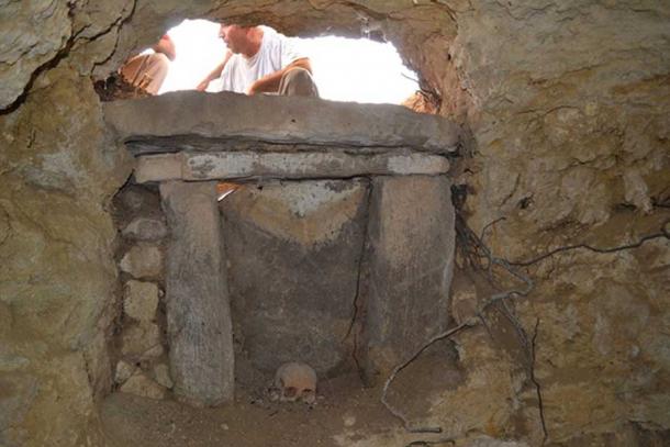The 2,500-year-old skull of a woman with cancer was found facing into an artificial cave that holds at least 50 burials. (Roberto Miccichè, Giuseppe Carotenuto & Luca Sìneo)