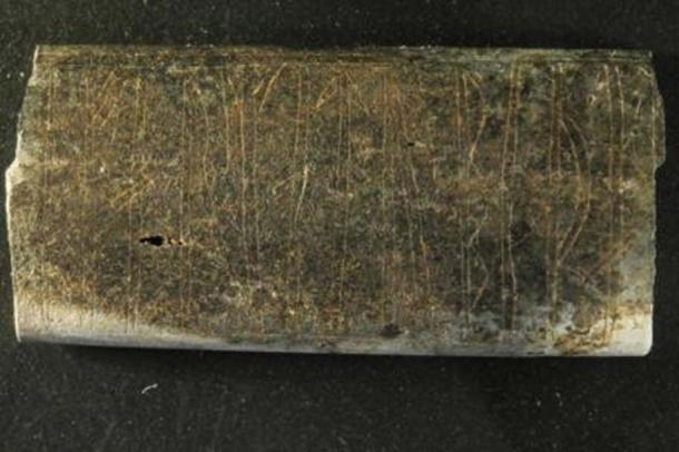The 3.8 by 1.8 centimeters bone plate had been burnt and otherwise deteriorated after more than 1,000 years in the ground.