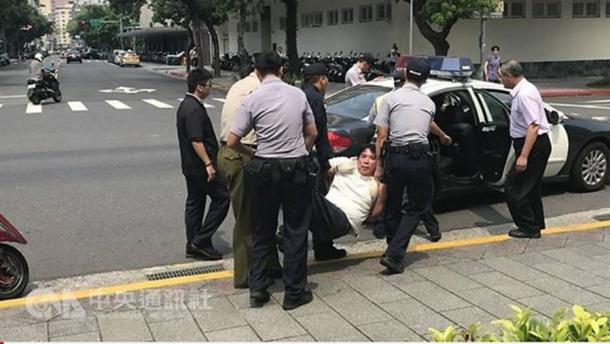 The assailant was taken away by officers after the attack. 