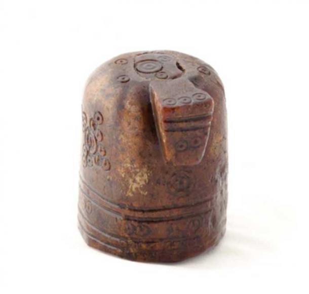 The chess or shatranj piece has a nose or snout, appearing to be a horse.