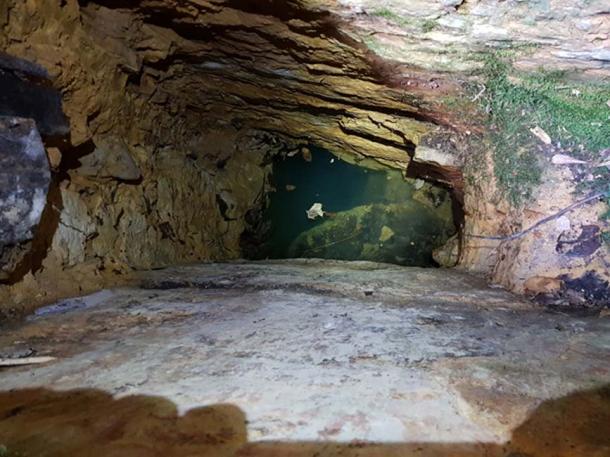 The entrance to the cave had been worked, but past the water line appeared to be a natural cave