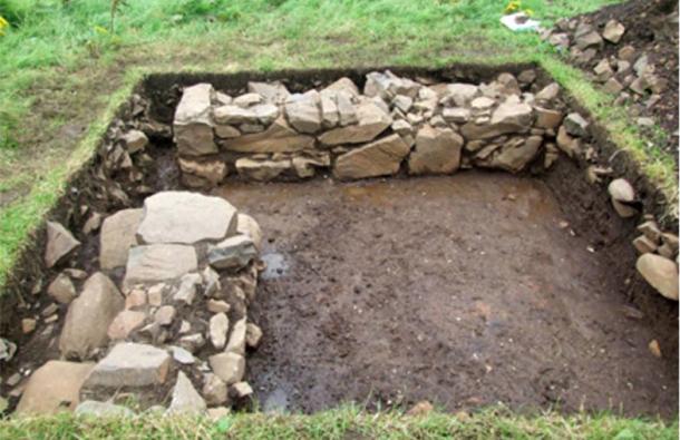 The excavated home with the doorway in the corner.