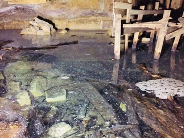 The flooded chamber has proven impossible to drain due to an unknown source of water. (Author supplied)