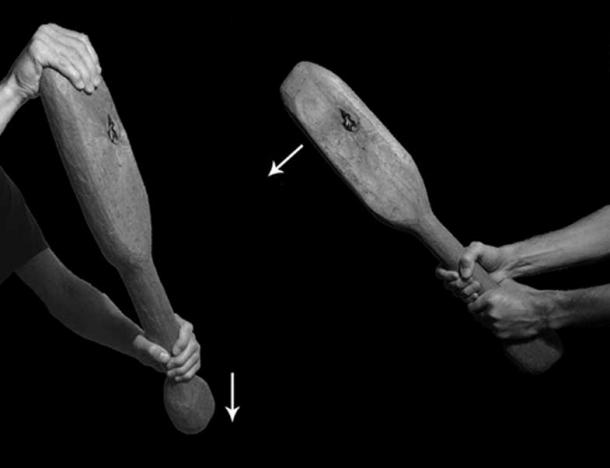The hand positions used to administer the two types of blow: left) the pommel strike; right) the double-handed strike. Arrows indicate direction of swing.