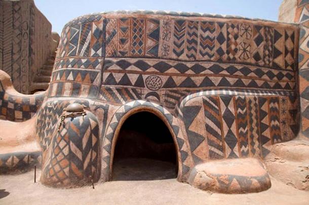 The only entrance into the beautifully painted home is through a small door less than a meter high.