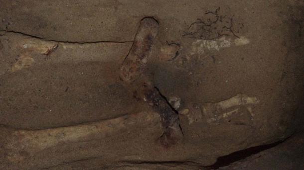 The shackles around the skeleton’s ankles.