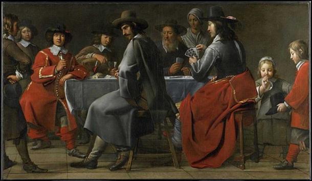 The small hurdy gurdy is barely visible under the arm and cloak of the player in this 17th Century painting. Gathering of Gamblers with Hurdy-Gurdy Player circa 1660.