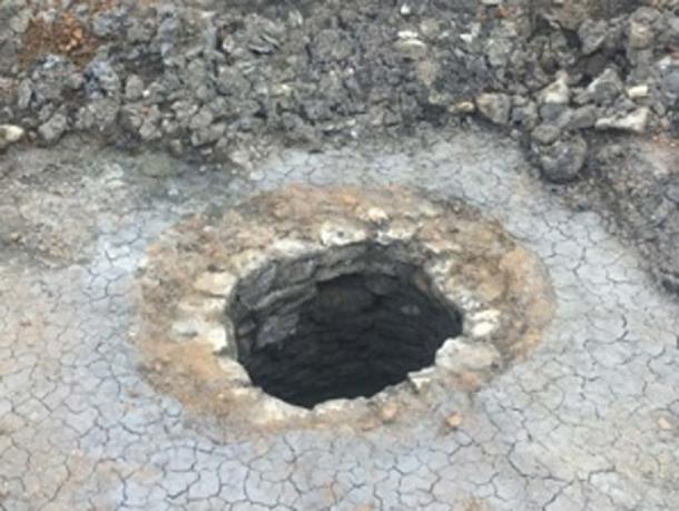 The stone-lined well which contained the wooden arm. (Oxford Archaeology)