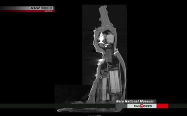 The whole body and head of the statue can be seen to contain artifacts. How they were placed there is as yet undetermined. (Image: NHK Newsline Screenshot)